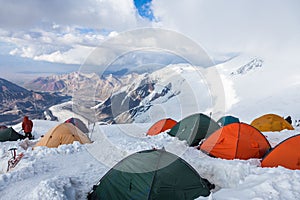 Mountain view from Lenin peak camp 4. Climbers preparing for summit attempt in their tents