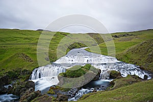 Mountain view of Skogarfoss waterfall, Iceland.