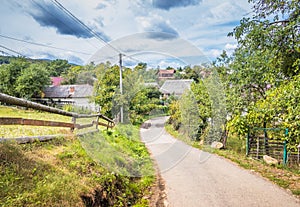 Mountain from view with small village sunny day. Sunny summer morning in the mountains and a small village. Country road in the