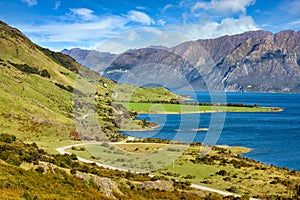 Mountain views and Lake Hawea. In summer there are green grass and blue skies with beautiful clouds