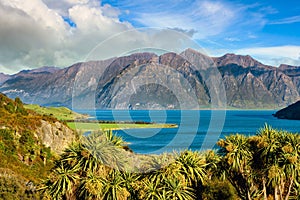 Mountain views and Lake Hawea. In summer there are green grass and blue skies with beautiful clouds