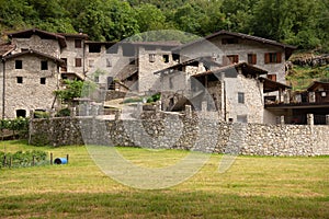 Mountain village architecture in Italy. Stone buildings in Camonica Valley photo