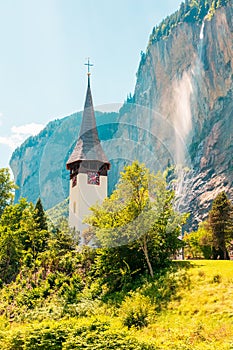 Mountain village, cliff and waterfall