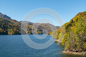 Mountain and water lake during autumn season with clear blue sky background