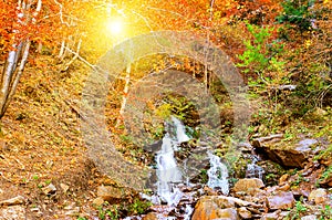 Mountain waterfall in the autumn forest