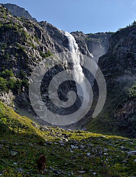 Mountain waterfall with a fast stream