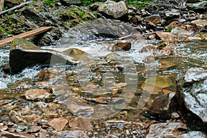 Mountain waterfall, large water flow of mountain waterfall, mountain river near the rock. Huk Waterfall, Ukrainian