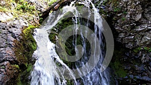 A mountain waterfall in a rocky gorge.