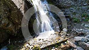 A mountain waterfall in a rocky gorge.