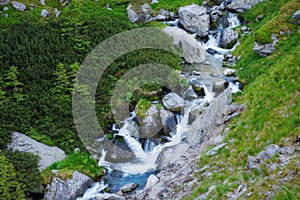 mountain waterstream among the rocks on the hillside