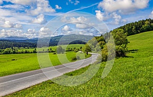 Mountain winding road in a green valley