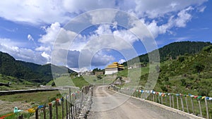 Mountain winding road with tibetan temple