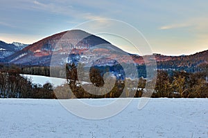 Mountain winter landscape illuminated by the last rays of the setting sun