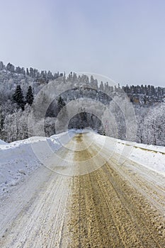 Mountain winter snow-covered road, morning sunrise in the mountains ,panoramic view from the tourist route.++