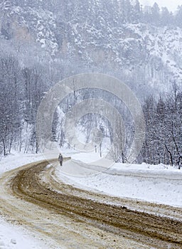 Mountain winter snow-covered road, morning sunrise in the mountains ,panoramic view from the tourist route.++