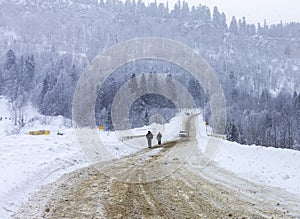 Mountain winter snow-covered road, morning sunrise in the mountains ,panoramic view from the tourist route.++