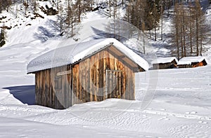 Mountain wooden cabin logs in the Dolomites, Passo Fedaia, Veneto, Italy