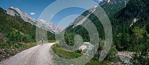 Mountainbiking along river Isar in the Karwendel mountains during blue sky day in summer, Austria