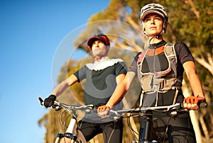 Mountainbiking kicks your level of awesomeness up a few notches. a young couple out mountain biking.