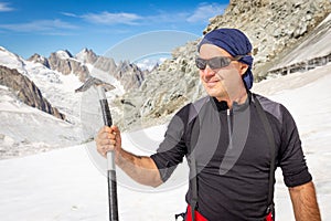 Mountaineer alpinist holding posing ice axe tool