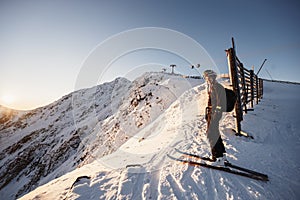 Mountaineer backcountry ski walking in the mountains. Ski touring in high alpine landscape. Adventure winter extreme sport. Sunny