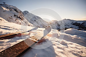 Mountaineer backcountry ski walking in the mountains. Ski touring in high alpine landscape. Adventure winter extreme sport. Sunny