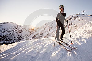 Mountaineer backcountry ski walking in the mountains. Ski touring in high alpine landscape. Adventure winter extreme sport. Sunny