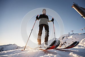 Mountaineer backcountry ski walking in the mountains. Ski touring in high alpine landscape. Adventure winter extreme sport. Sunny