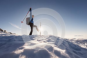 Mountaineer backcountry ski walking in the mountains. Ski touring in high alpine landscape. Adventure winter extreme sport. Sunny