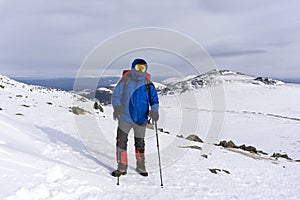 Mountaineer on a background of a winter mountain landscape