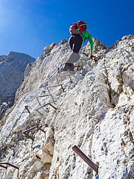 Mountaineer climbing the vertical just below the top of the mountain