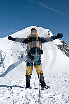 Mountaineer embracing peak