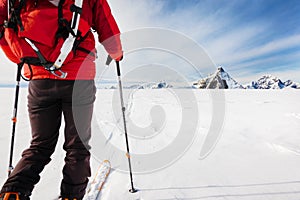 Mountaineer exploring a glacier with the skis during a high-altitude winter expedition in the european Alps.