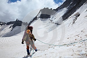 Mountaineer girl belaying friends by rope