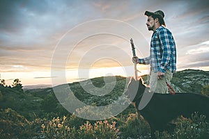 Mountaineer with his dog in the mountains