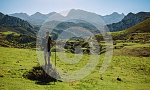 Mountaineer looking landscape with path between mountains