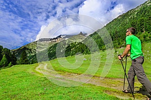 Mountaineer with poles on alpine trail, Austria