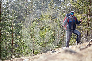 Mountaineer with poles mountaineering on mountain