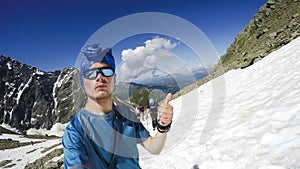 Mountaineer reaches the top of a snowy mountain