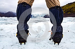 Mountaineer`s feet with crampons on the frozen glacier, Vatnajokull