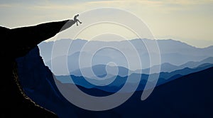 Mountaineer sitting on rocky outcropping photo