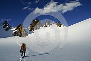 Mountaineer on a snow-covered glacier in the eveni