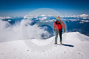 Mountaineer on snowy mountain top.