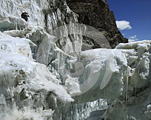 Mountaineer staring on a grand crevasse with a thi