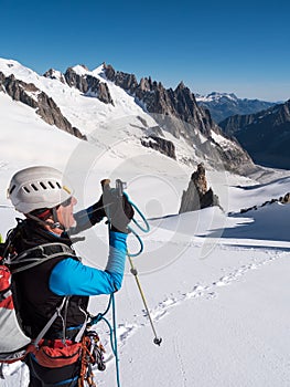 Mountaineer taking picture with a camera in the mountains.