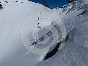 Mountaineer team doing winter trekking in unusual, dangerous, scary mountains