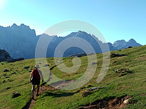 A mountaineer hiking near Vega de Ario, in The Anillo of Picos de Europa, Spain