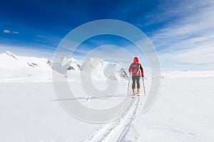 Mountaineer walking on a glacier during a high-altitude winter e