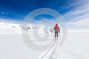 Mountaineer walking on a glacier during a high-altitude winter e photo