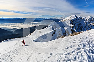 The mountaineer walking on the top of the ridge